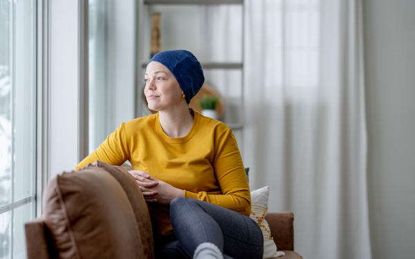 iStock image of a cancer patient smiling and looking out a window | Icon Cancer Centre