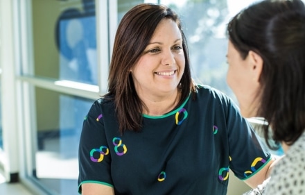 Icon staff member talking to a patient