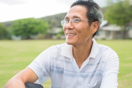 Happy older person sitting in the park.