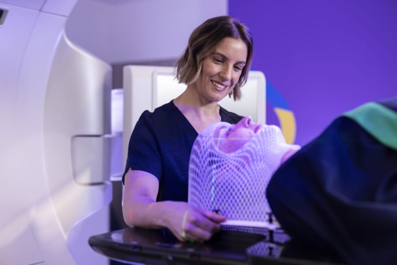 Cancer care specialist delivering treatment to a patient.