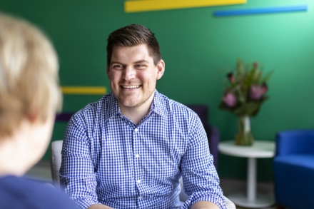 Smiling specialist consulting cancer patient