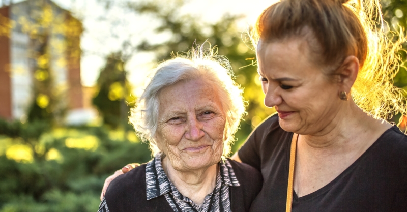 Mature adult woman walking with her mother