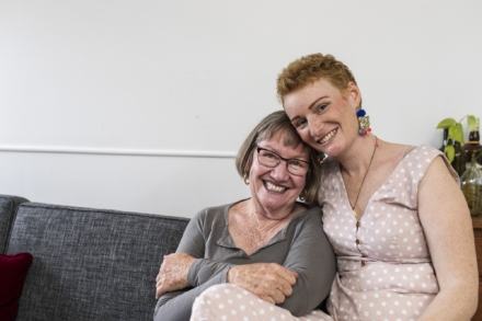 Two people smiling on couch