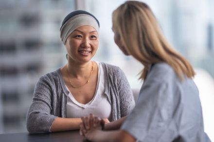 Cancer patient smiling at treatment consultant.