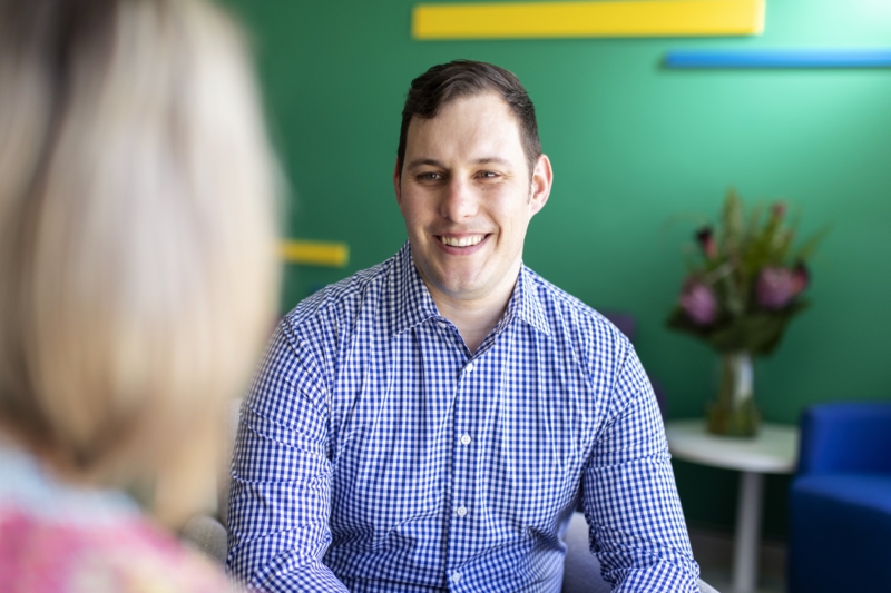 Icon specialist smiling at cancer patient.