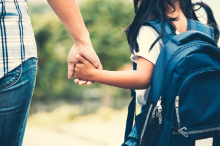 Young child holding adult's hand