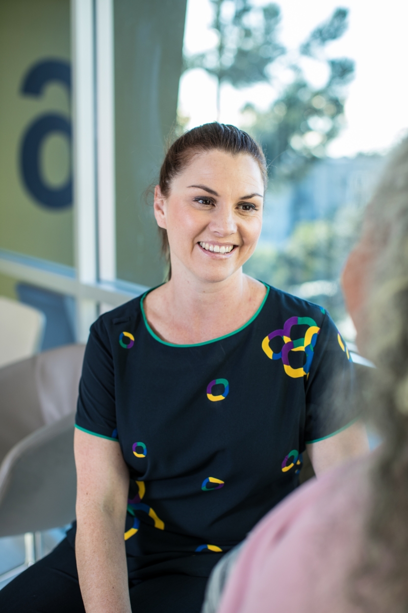 Cancer care team member smiling at patient.
