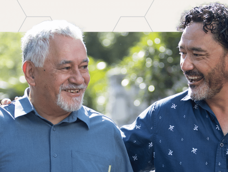 Two gentlemen smiling.
