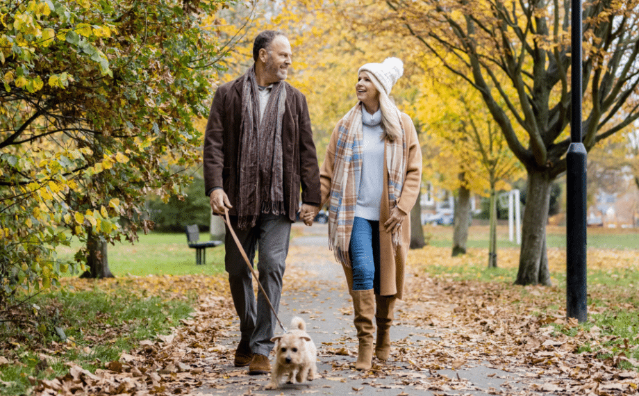 Two happy people walking in a park.