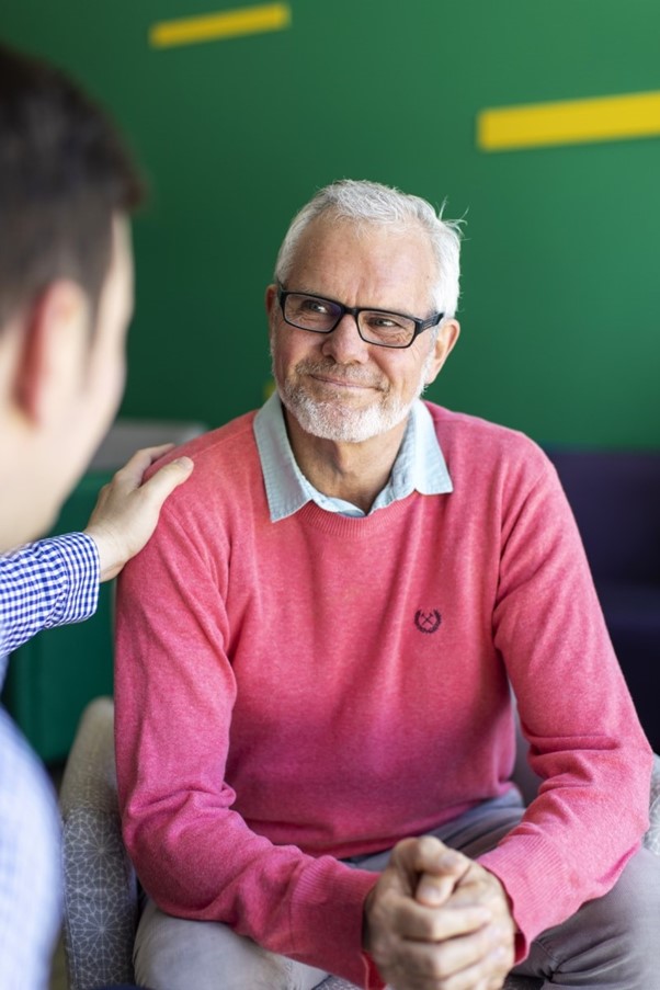 Smiling cancer patient with care team member