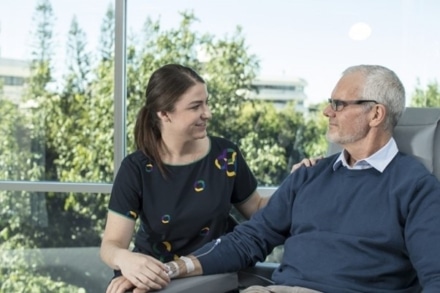 Cancer treatment therapist caring for patient.