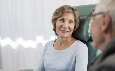Cancer consultant reassuring patient.