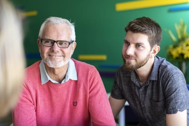 Father and son getting treatment advice and smiling